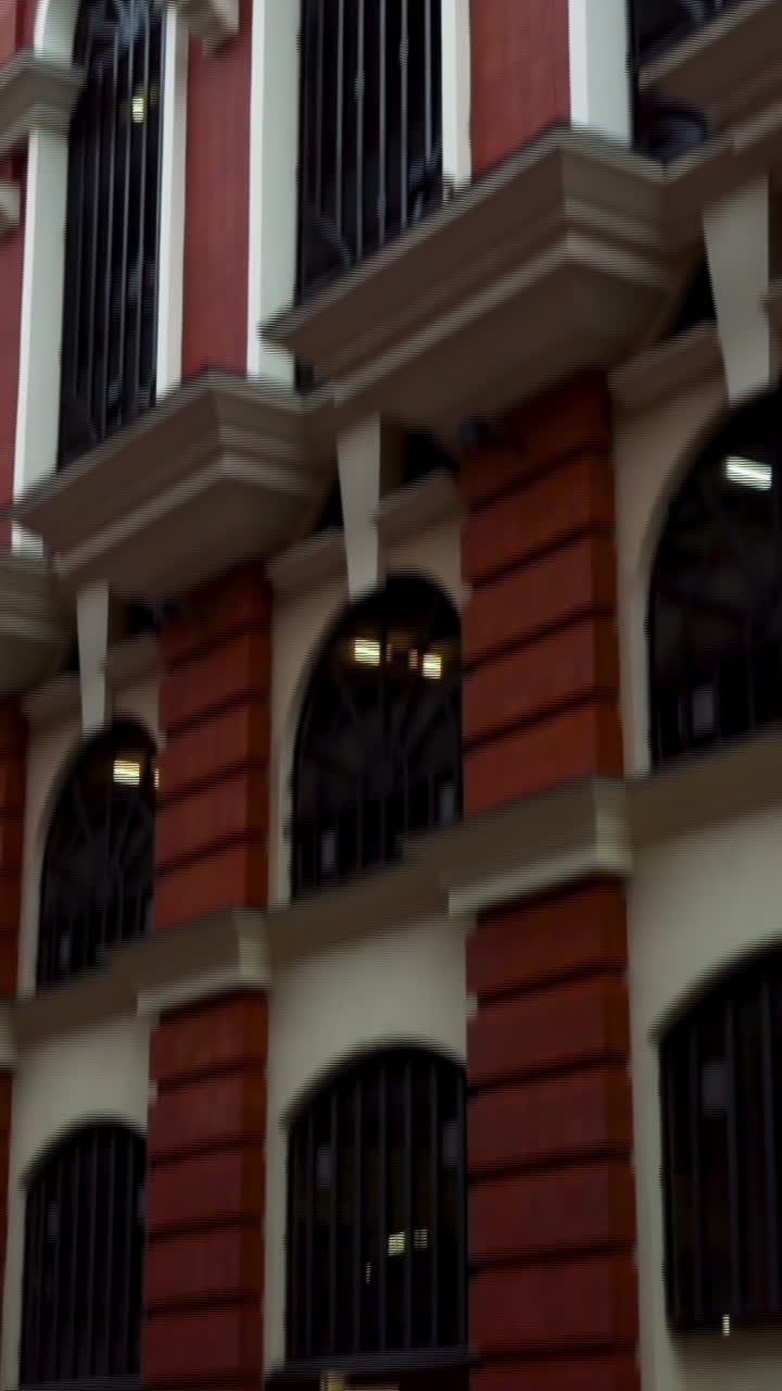 Exterior of a historic building with red brick and arches