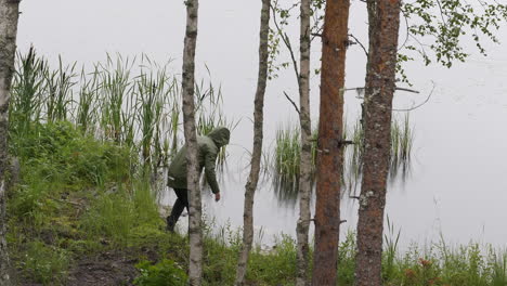 Nature-Photographer-accidentally-drop-camera-in-lake-water,-long-shot