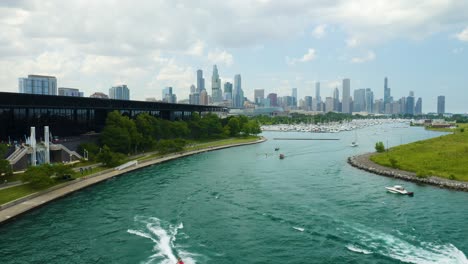 boats exiting and entering chicago habor with skyline in background