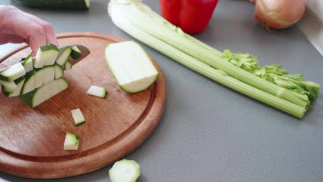 slow motion of cutting a courgette into cubes