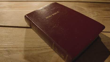 religious concept shot of old bible on wooden table 1