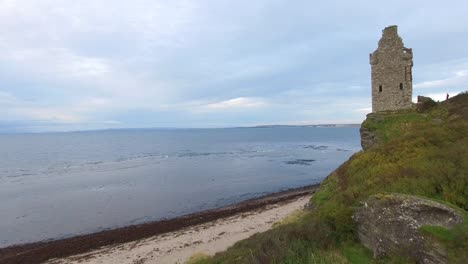 Ruins-of-ancient-Scottish-castle-on-lakefront-headland