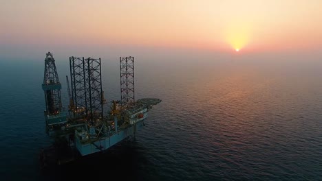 ws aerial view of the gas platform at sunset