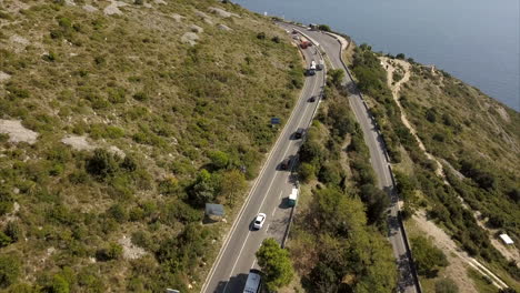 Hill-side-roads-in-Croatia-with-slow-reveal-of-beautiful-blue-sea-on-a-sunny-day