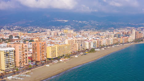 Aerial-drone-hyperlapse-timelapse-pull-away-of-Fuengirola-beachfront-in-Spain-in-winter