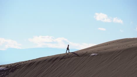 Hiking-over-sand-dunes-on-a-sunny-day