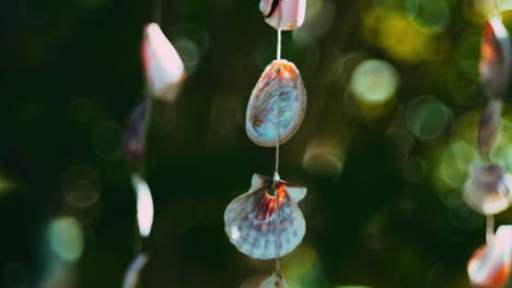 Hanging-mobile-close-up,-crafted-from-shells-and-seashells-from-the-seaside-moving-in-the-wind