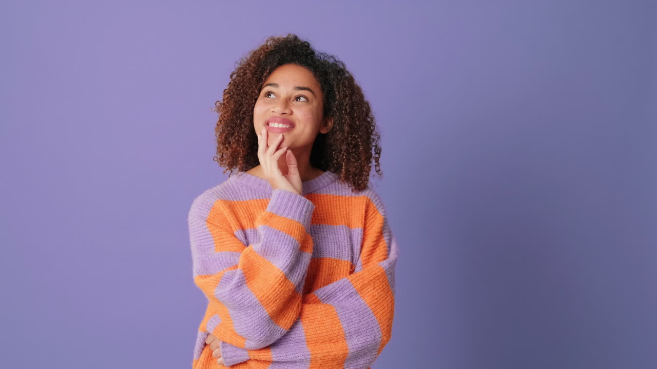 Thoughtful Young African American Woman Pondering and Smiling