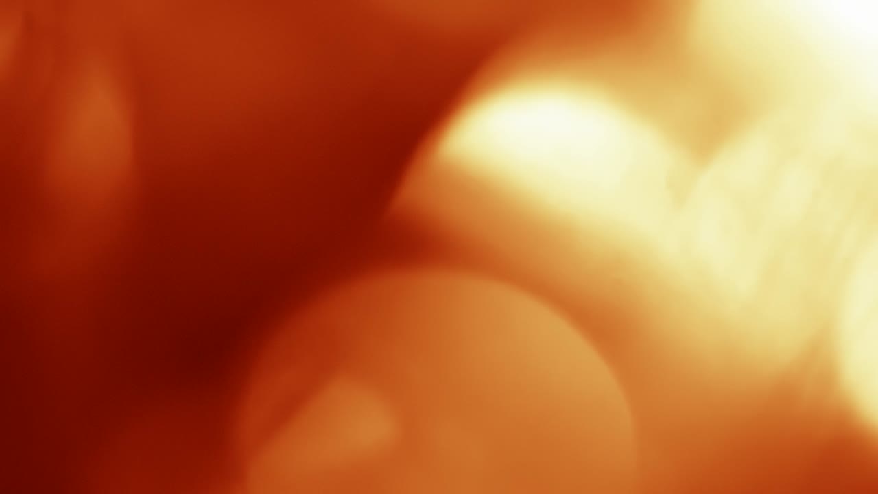 Dynamische rote und orangefarbene Bokeh-Lichtreflexe