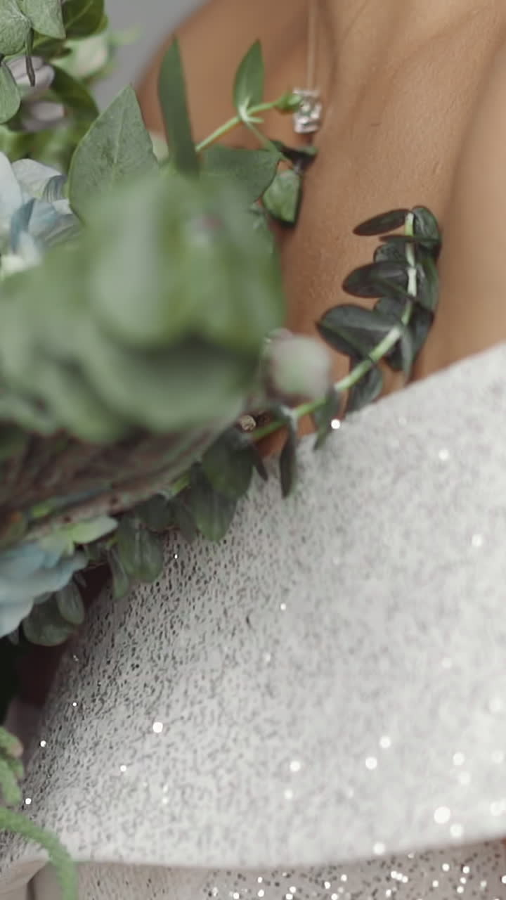 Young bride takes fresh bouquet from beloved groom at wedding ceremony in palace closeup. Happy event in loving couple life. Holiday celebration