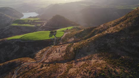 Aerial-pull-back-of-vibrant-rolling-hills-and-beams-of-sunlight-in-the-Napa-Valley