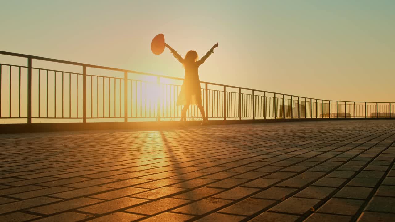 A Joyous Moment at Sunset: Capturing the Essence of Freedom and Happiness as a Figure Celebrates with Joyful Expression Against a Golden Horizon