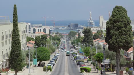 cars running and people walking in german colony, haifa, israel