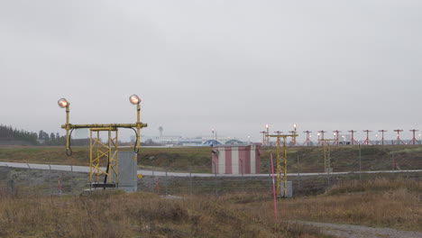 Panning-over-aviation-landing-approach-lights,-during-fall-day,-airport