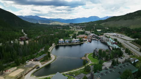 Pond-lake-mirror-reflection-clouds-Keystone-Blue-River-ski-resort-summer-Breckenridge-Colorado-Vail-resort-Epic-Pass-aerial-cinematic-drone-ski-snowboard-bike-biking-biker-path-slowly-forward-motion