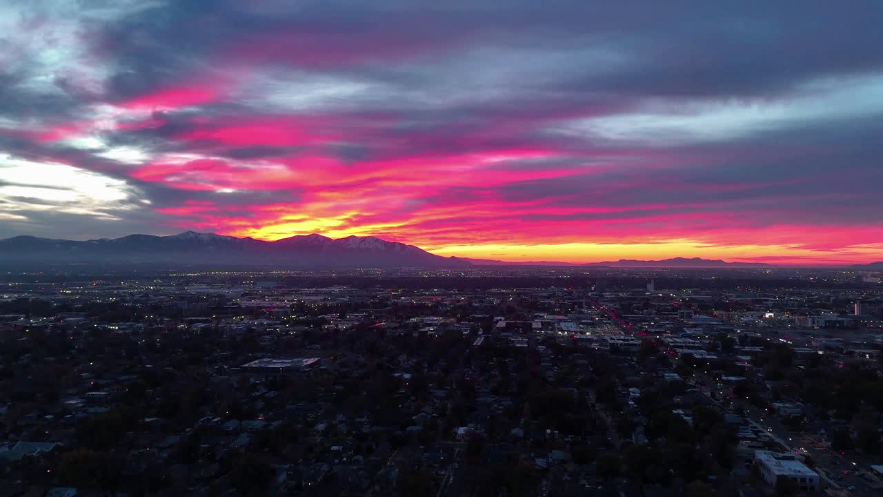 Aerial Salt Lake City skyline with mountains at sunset