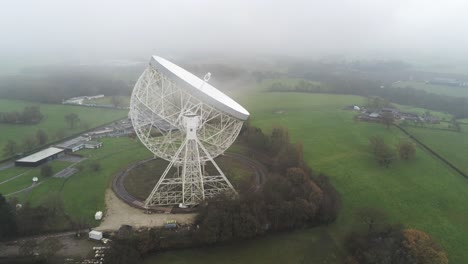 aerial jodrell bank observatory lovell telescope misty rural countryside slow descend side view