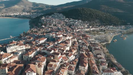 A-drone-shot-of-village-green-mountain,-warm-weather,-flying-above-a-dreamy-town-hill,-4K-video,-European-spring-nature,-beautiful-landscape,-scenic-clear-water-lake