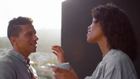 couple discussing while having coffee in balcony 4k