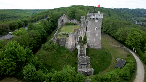 pull back aerial view of chateau ruins in french countryside next to freeway