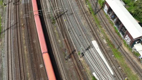 Aerial-tracking-shot-of-a-train-passing-near-Darmstadt,-Germany