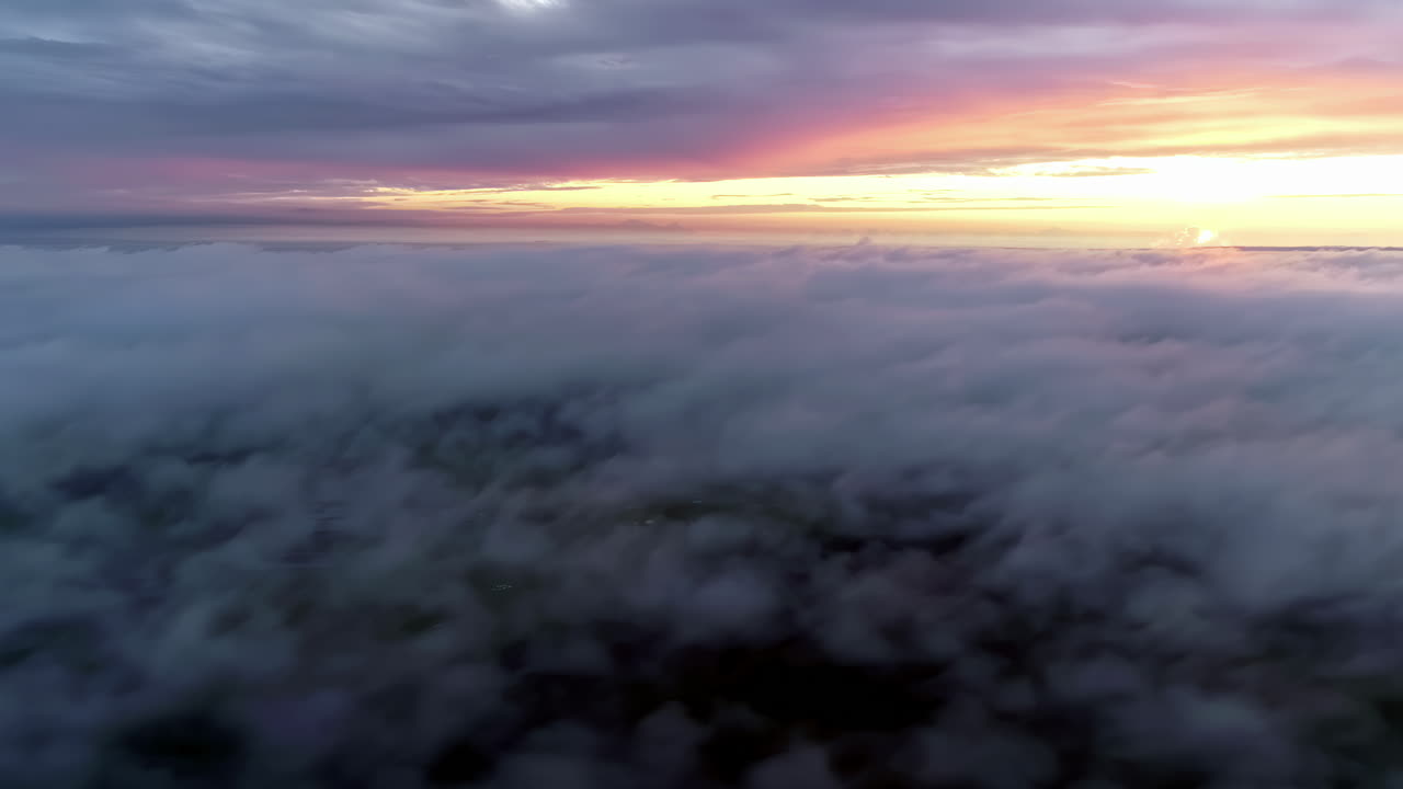 Aerial above dramatic beautiful golden sun sunset over thick clouds