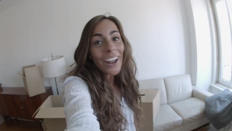 happy woman having a video call via smartphone, smiling and talking about new house