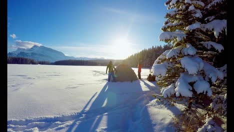 couple preparing a tent on snowy landscape 4k