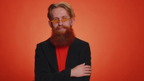 Cheerful-lovely-bearded-redhead-man-fashion-model-in-jacket-smiling-and-looking-at-camera-alone