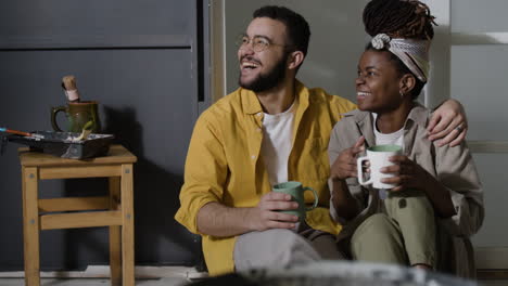 Couple relaxing together after painting