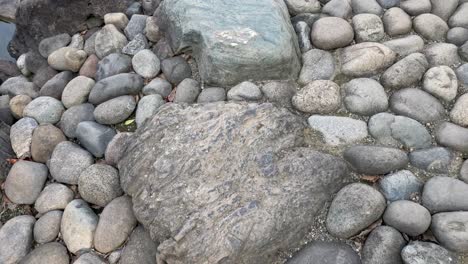 various stones and pebbles near a water body