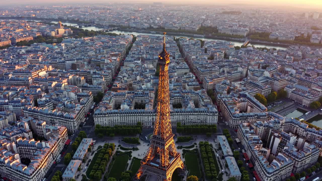 Aerial video captures the Eiffel Tower at sunset, showcasing Paris's sprawling cityscape from a high