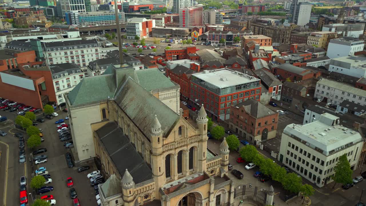 Ascending aerial video of St Anne's Cathedral in the Cathedral Quarter in Belfat City Centre, Northern Ireland on a bright and sunny day. Filmed in 4K, 60FPS and with Rec709 Color.