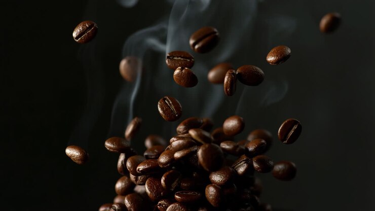 Roasted Coffee Beans Falling with Steam