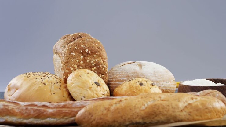Bread loaves with wheat grains and flour