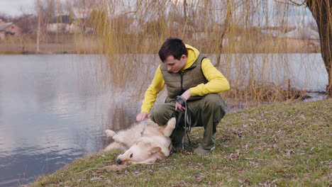 man and dog by the lake