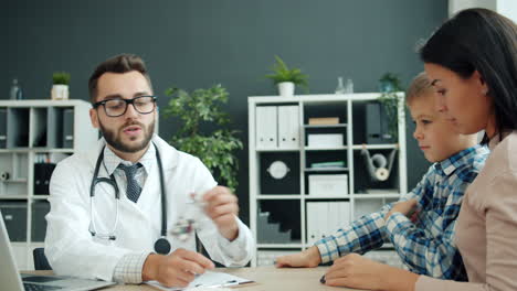 doctor discussing medication with child and mother