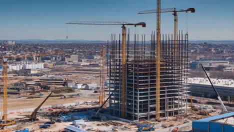 high-rise building construction with cranes and cityscape