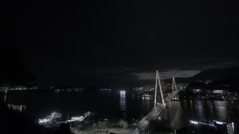 night view of a city with a bridge and water