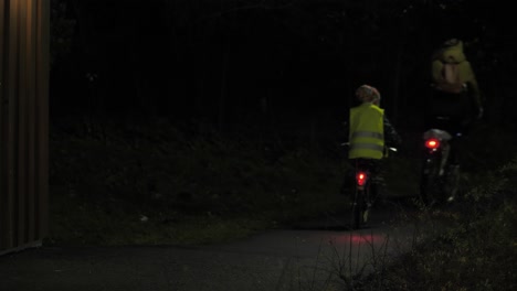 a cyclist rides at night in an urban environment