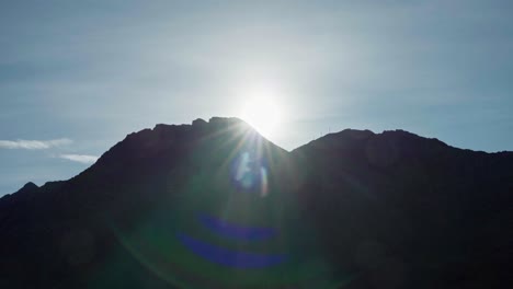 morning sunshine over mountain peak silhouette during sunrise in norway