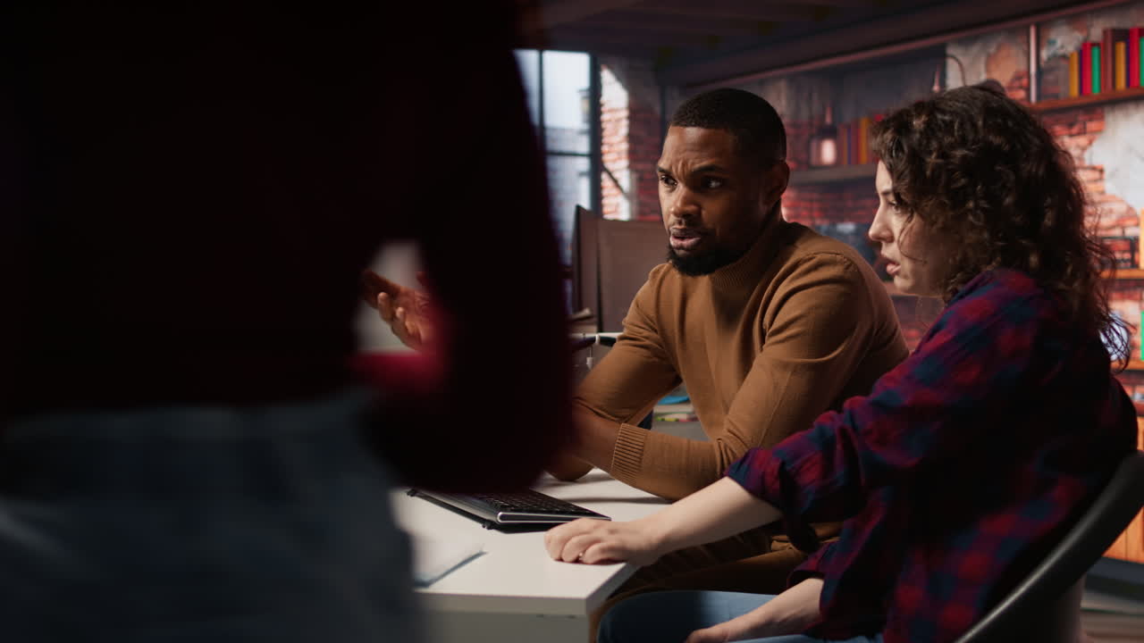 IT employees in startup office working at computer desks
