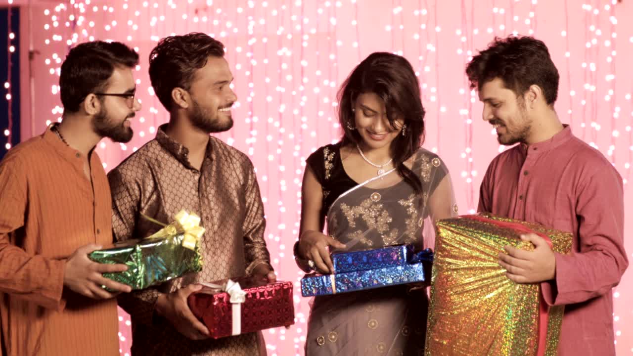 close friends in a traditional cloths are meeting and sharing gifts during Diwali festival