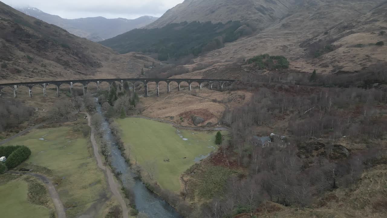 스코틀랜드의 역사적인 glenfinnan viaduct는 거친 풍경으로 둘러싸여 있습니다.