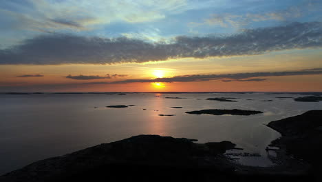 Aerial-beautiful-sunset-with-vivid-and-cinematic-colours-at-a-rocky-coastline-with-islands