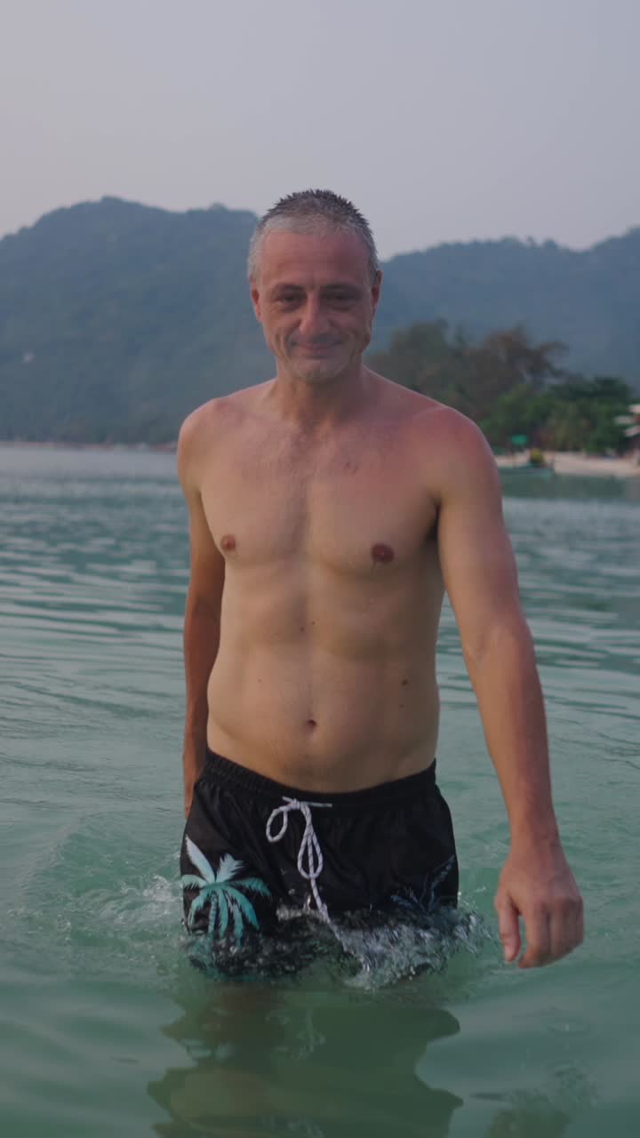 Man in swim trunks in the sea