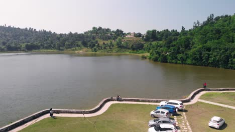 Breathtaking-view-of-Tikkar-Taal-lake-surrounded-by-mountains-located-in-the-Haryana