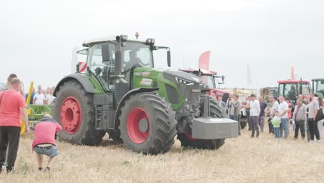 demonstration of agricultural machinery at an exhibition. tractors operate in the field, showcasing their capabilities and performance in action