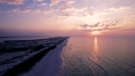 Drone-at-sunrise-over-the-white-sand-emerald-waters-of-the-Gulf-of-Mexico-in-Pensacola,-Florida