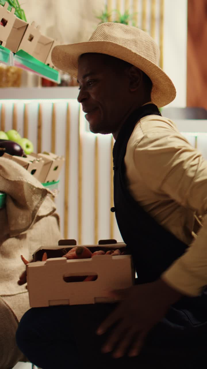 Vertical Video Local farmer placing crates with homegrown produce on shelves